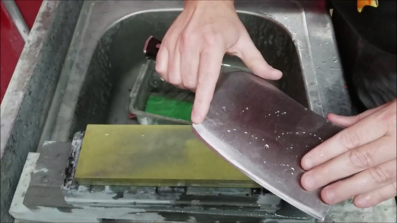 Sharpening a meat cleaver on a water stone